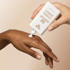 Yon-Ka Paris 50+ Mineral Fluid Broad Spectrum Sunscreen (60 ml) - product shown being appleid to back of hand. 