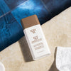 Yon-Ka Paris 50+ Mineral Fluid Broad Spectrum Sunscreen (60 ml) - product shown on edge of pool. 