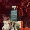 Lifestyle shot of Ormonde Jayne Oud Liaisons Eau de Parfum (88 ml) on a rock with crystals with smoke effects in the background