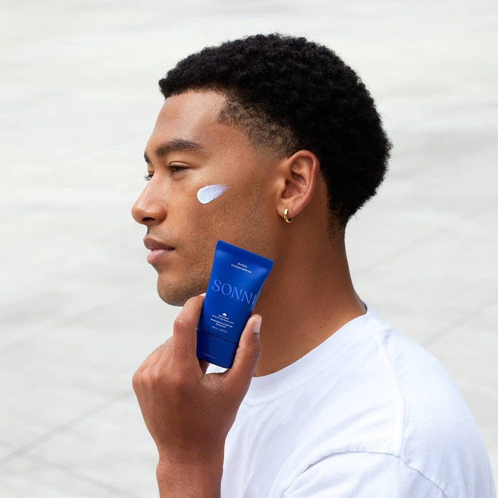 SONNI SunDay Invisible Defense SPF 40+ (38 ml) - product shown being applied to model's face. 