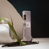 Lifestyle shot of Morn to Dusk Eau de Parfum Spray (10 ml) - product shown in front of paper with vanilla in front. 