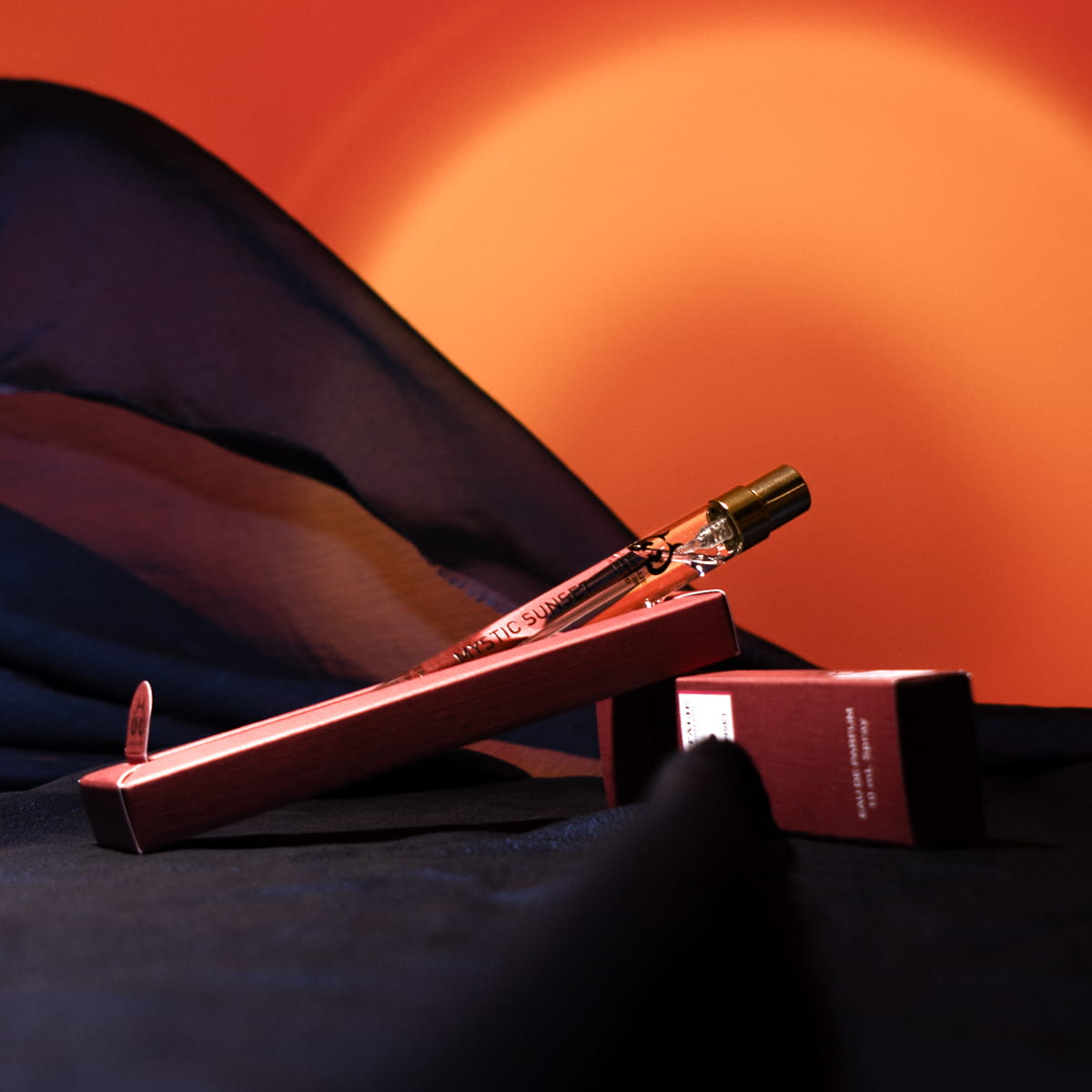 Eau d'Italie Mystic Sunset Eau de Parfum Spray (100 ml)  - product shown with packaging on black chiffon fabric. 