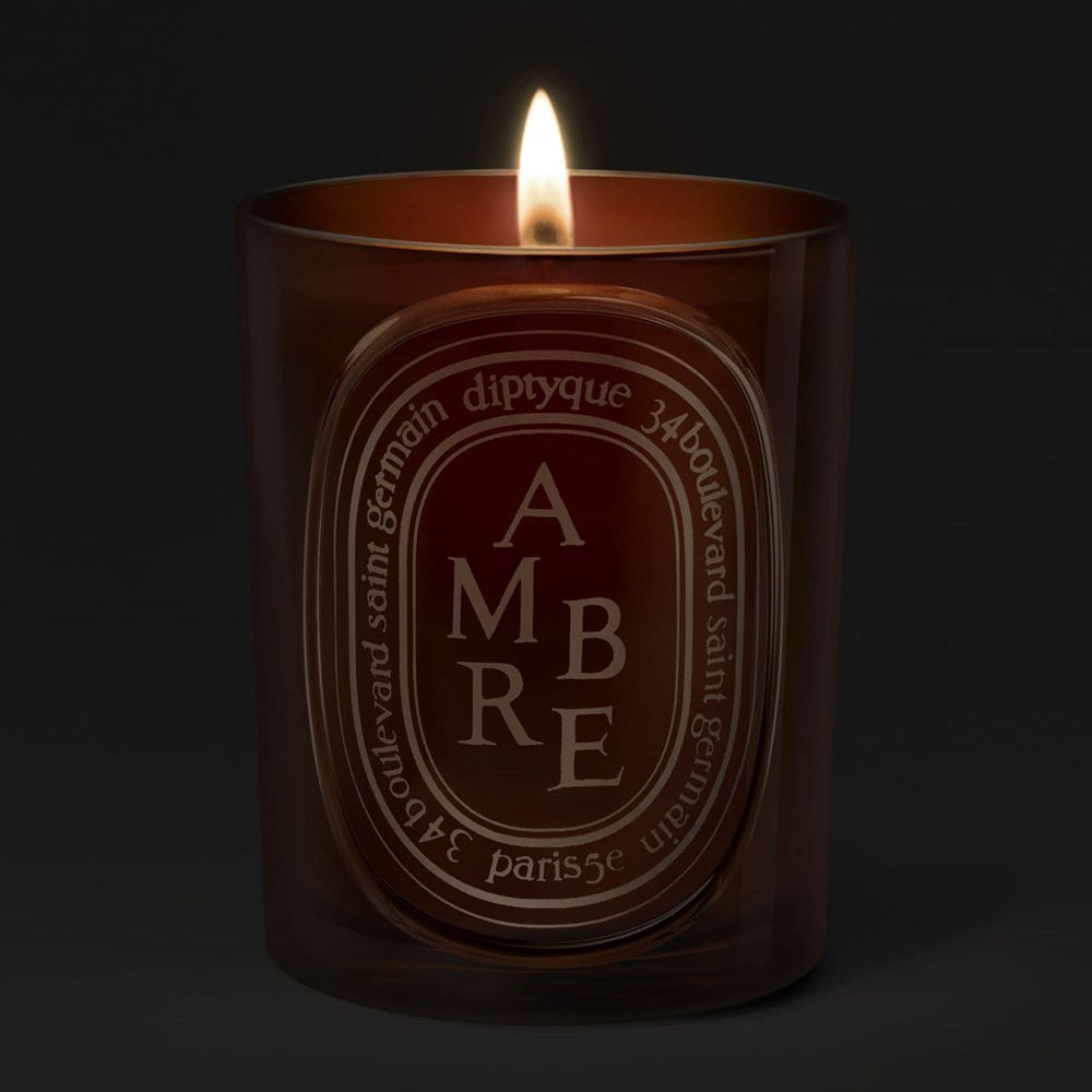Diptyque Ambre (Amber) Medium Candle (300 g) - product shown lit. 