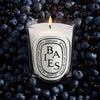 Diptyque Baies (Berries) Classic Candle (190 g) - product shown on top of blueberries. 