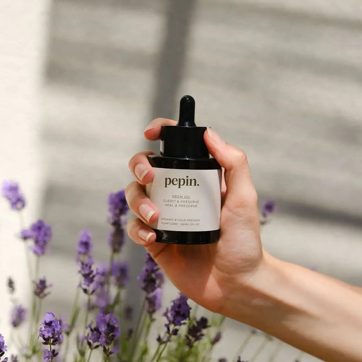 Pepin Neem Oil (60 ml) - product shown with lavender flowers in the background.