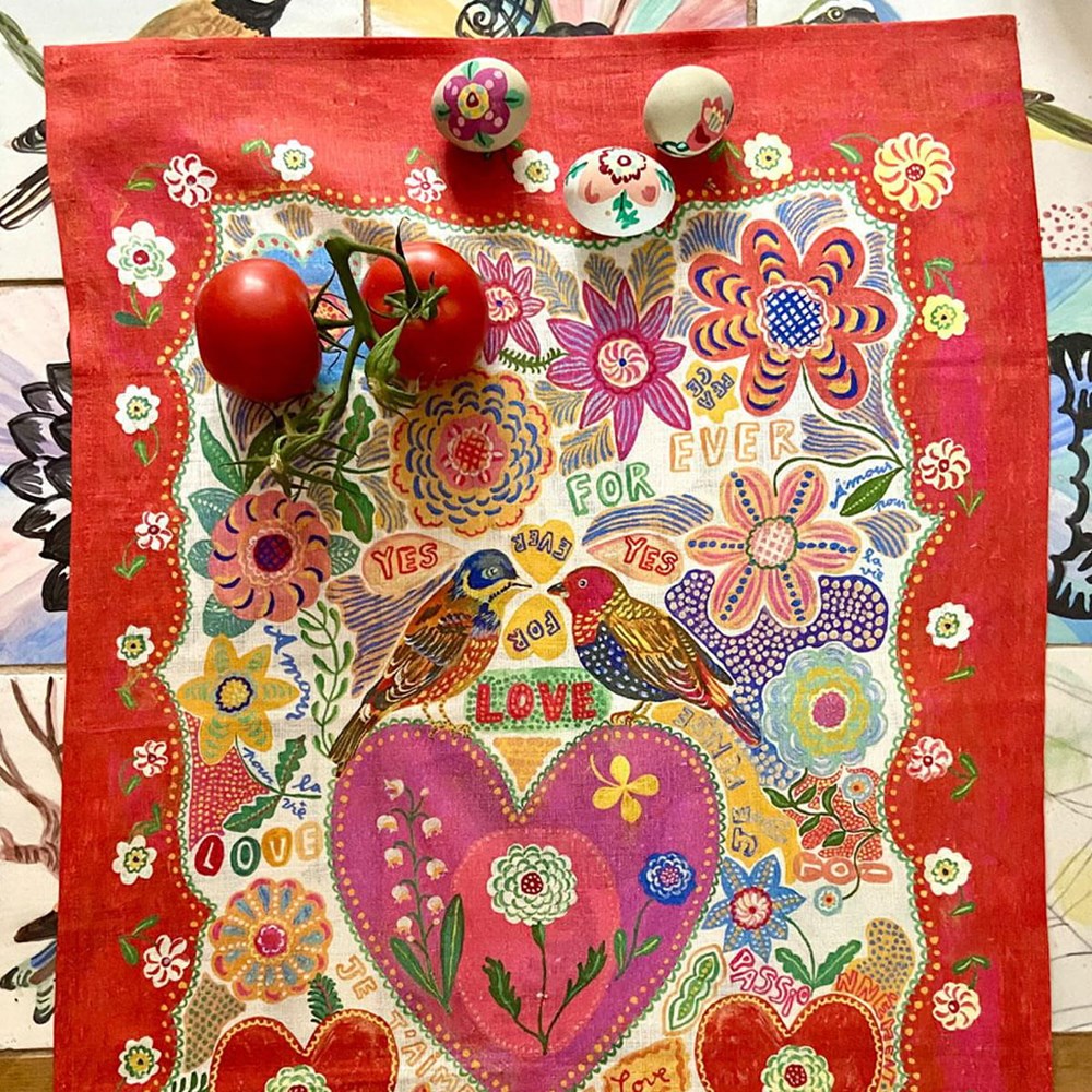 Avenida Home Nathalie Lete For Ever Tea Towel (1 pc) - product shown on a counter with eggs and tomatoes on top.