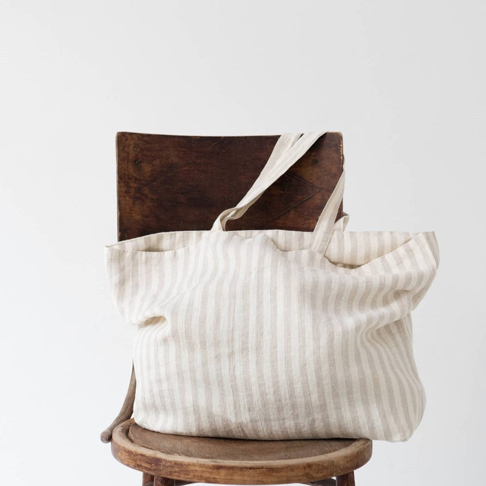 Linen Tales Linen Big Bag - Natural White Stripes (1 pc) - product shown on chair. 