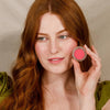 Minori Cream Blush - Sweat Pea (4.9 g) - product shown being held by model. 