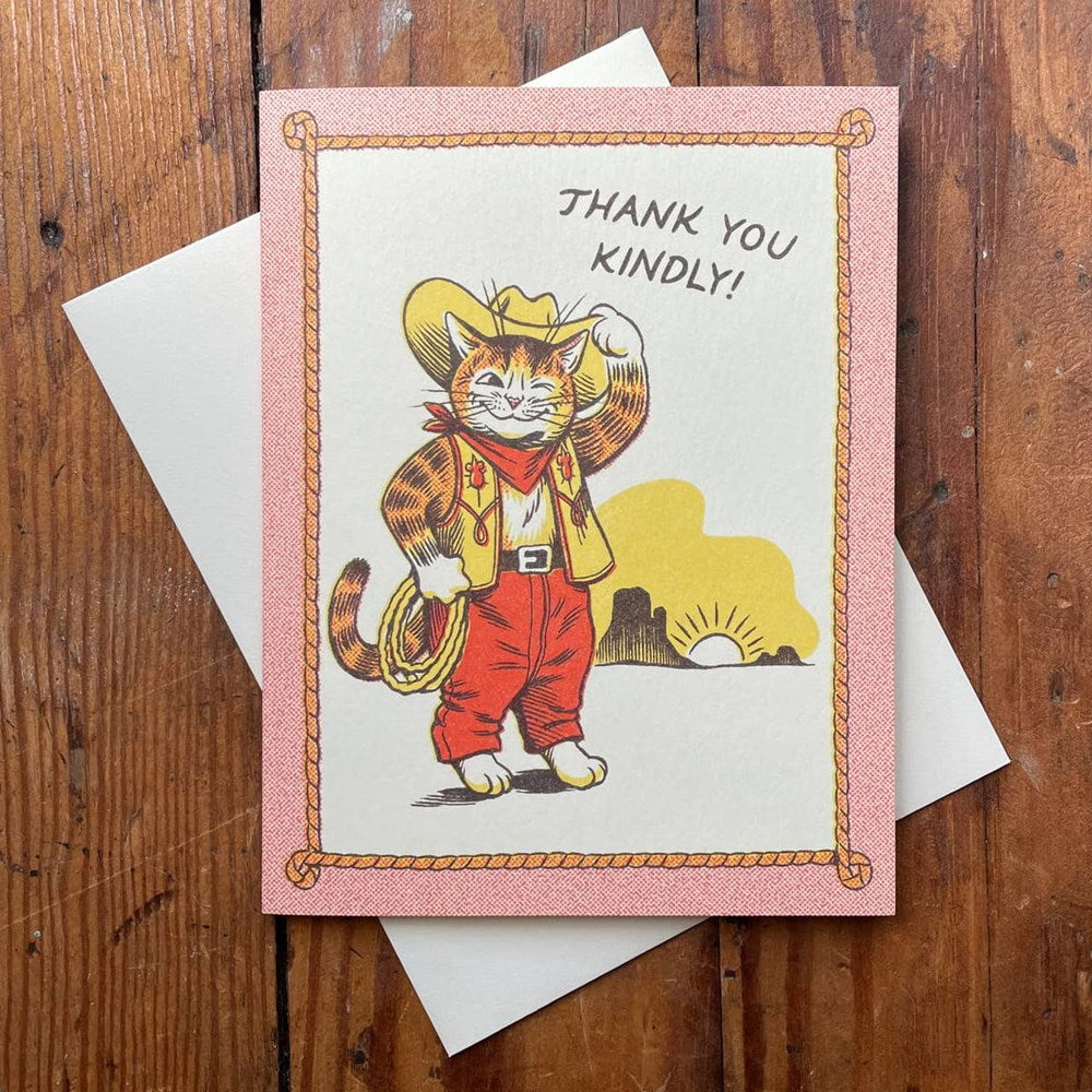 Lifestyle shot of Wallflower Paper & Party Thank You Kindly Card (1 pc) shown with envelope on wood table