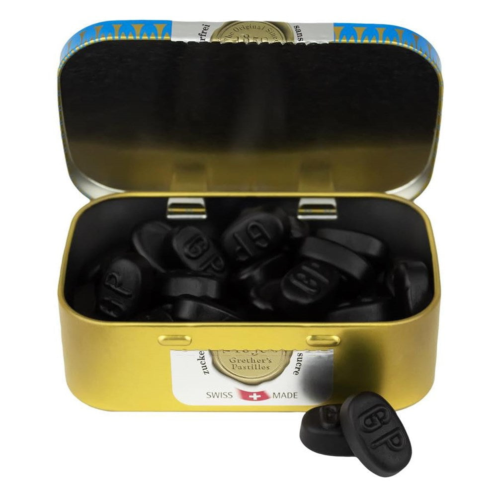 Grether’s Pastilles Blackcurrant Tin - Sugarfree (110 g) shown open with pastilles inside and 2 shown in front of tin