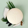 Kate McLeod Tonka Bean & Coconut Deep Moisturizing Lotion Bar (3.5 oz) -product shown with ingredients on a green background.