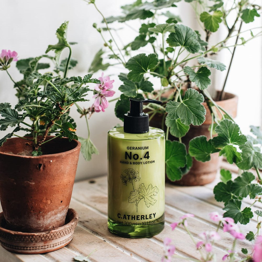 C.Atherley Geranium No.4 Hand & Body Lotion (300 ml) - product shown on wooden counter with plants. 