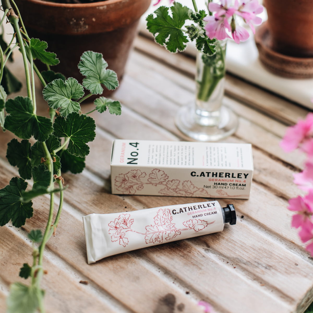 C.Atherley Geranium No.4 Hand Cream (30 ml) - product shown with box on a wooden counter. 