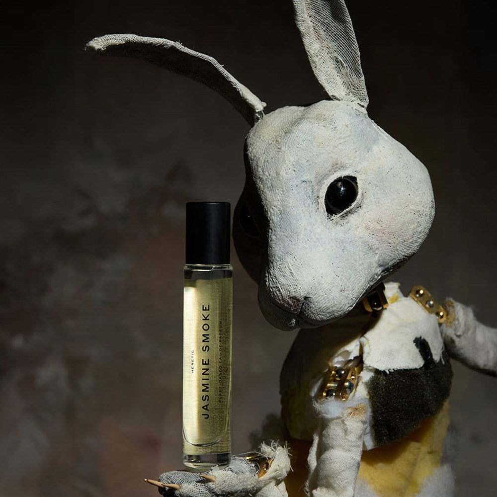 Heretic Parfum Jasmine Smoke Eau de Parfum (15 ml) - product shown being held by a bunny doll. 