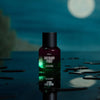 Heretic Parfum Rhubarb Thief Eau de Parfum (50 ml) - product shown on blue counter with moon in the background.