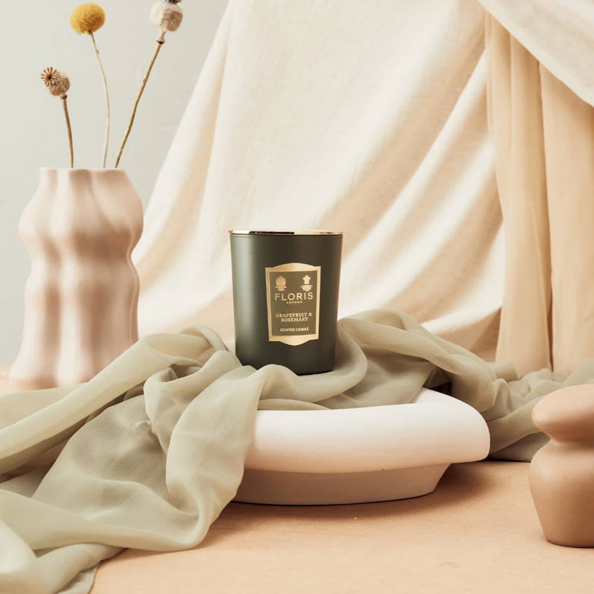 Floris London Grapefruit &amp; Rosemary Scented Candle (1.75 ml) - product shown on green fabric. 