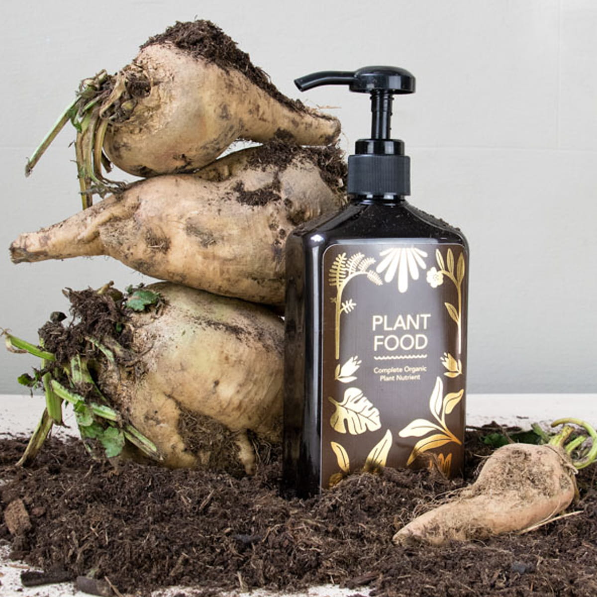 Botanopia Complete Organic Plant Food (450 ml) - product shown in front of dirt. 