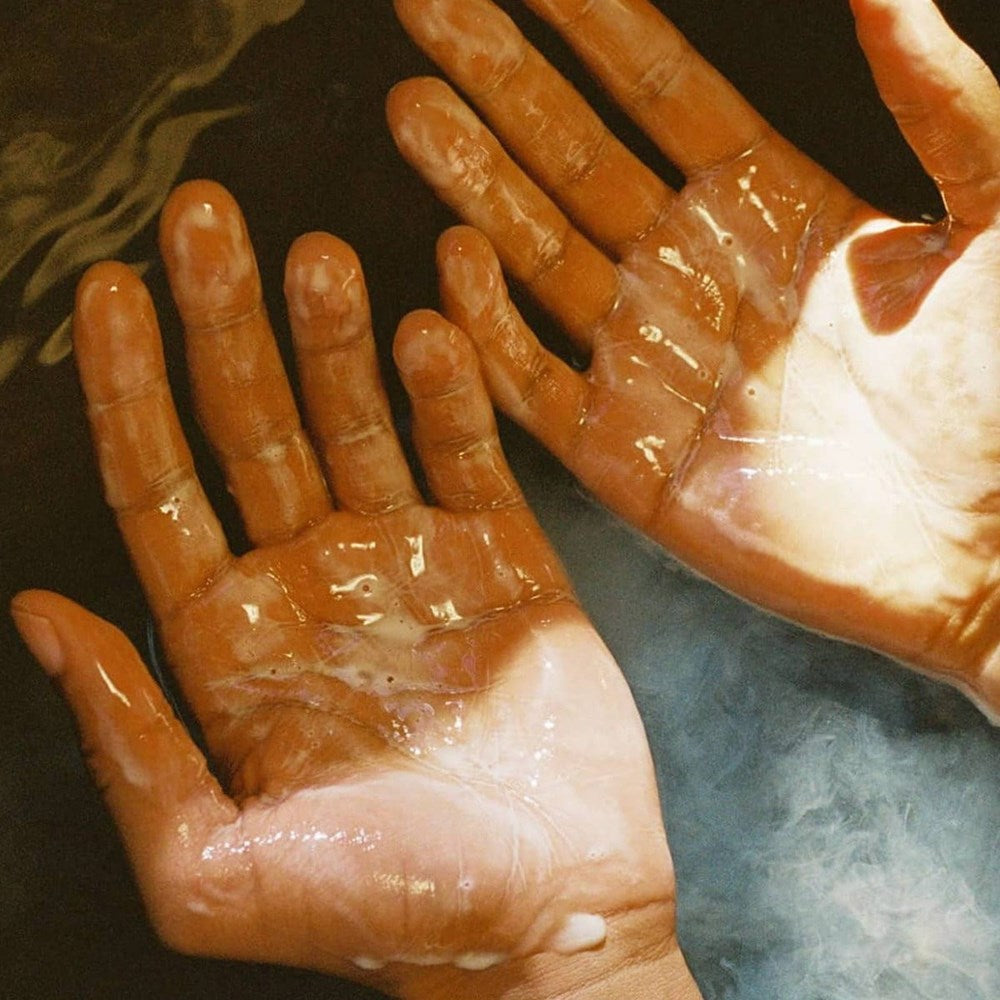 Flamingo Estate Organics Rosemary Clary Sage Glass Hand Soap (325 ml) - product shown on persons hand. 