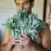 Man holding a large bouquet of sage