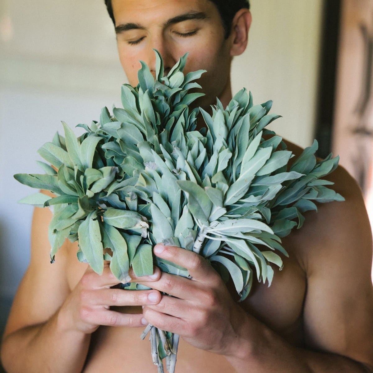 Man holding a large bouquet of sage