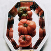 Decorative mirrored tray with three heirloom tomatoes.
