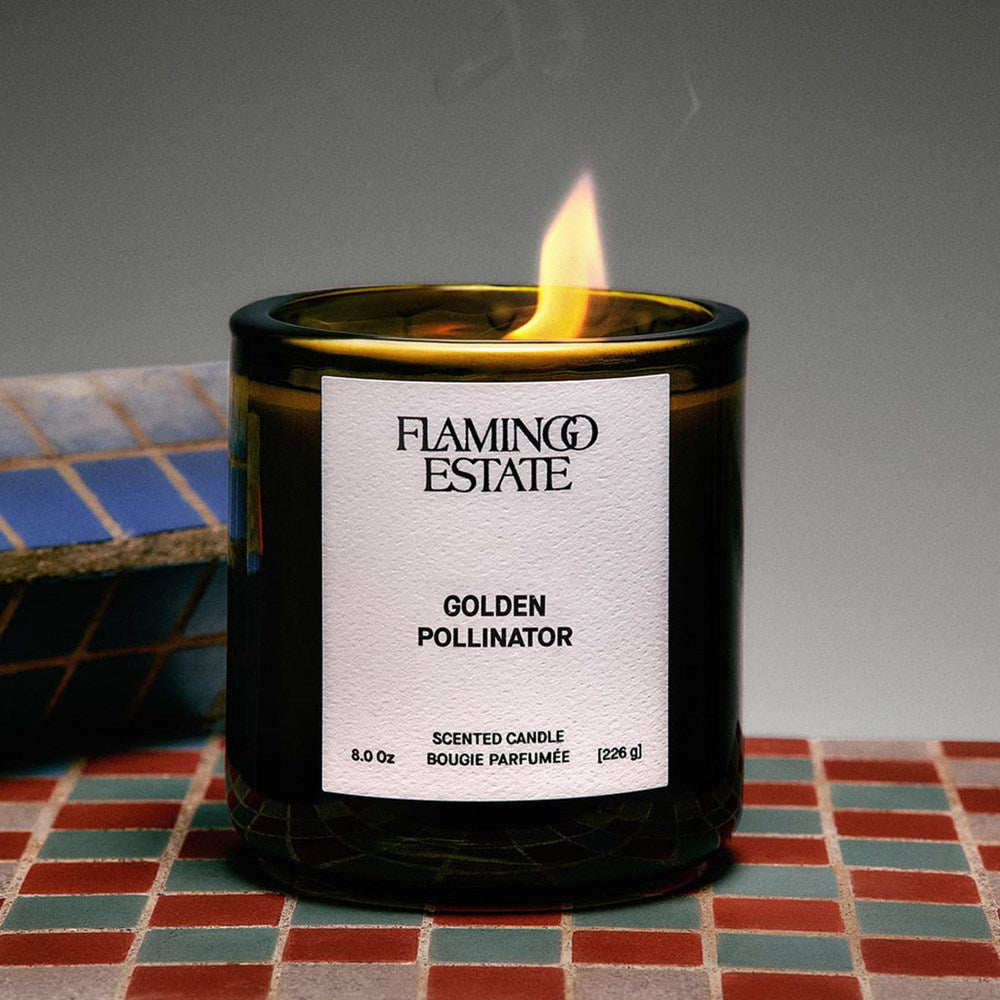 Lifestyle shot of Flamingo Estate Organics Golden Pollinator Candle (226 g) shown burning