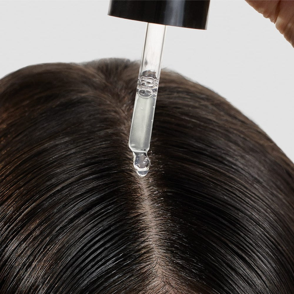 Cosmetics 27 Hair & Scalp Serum (50 ml) - product shown being applied to hair & scalp. 