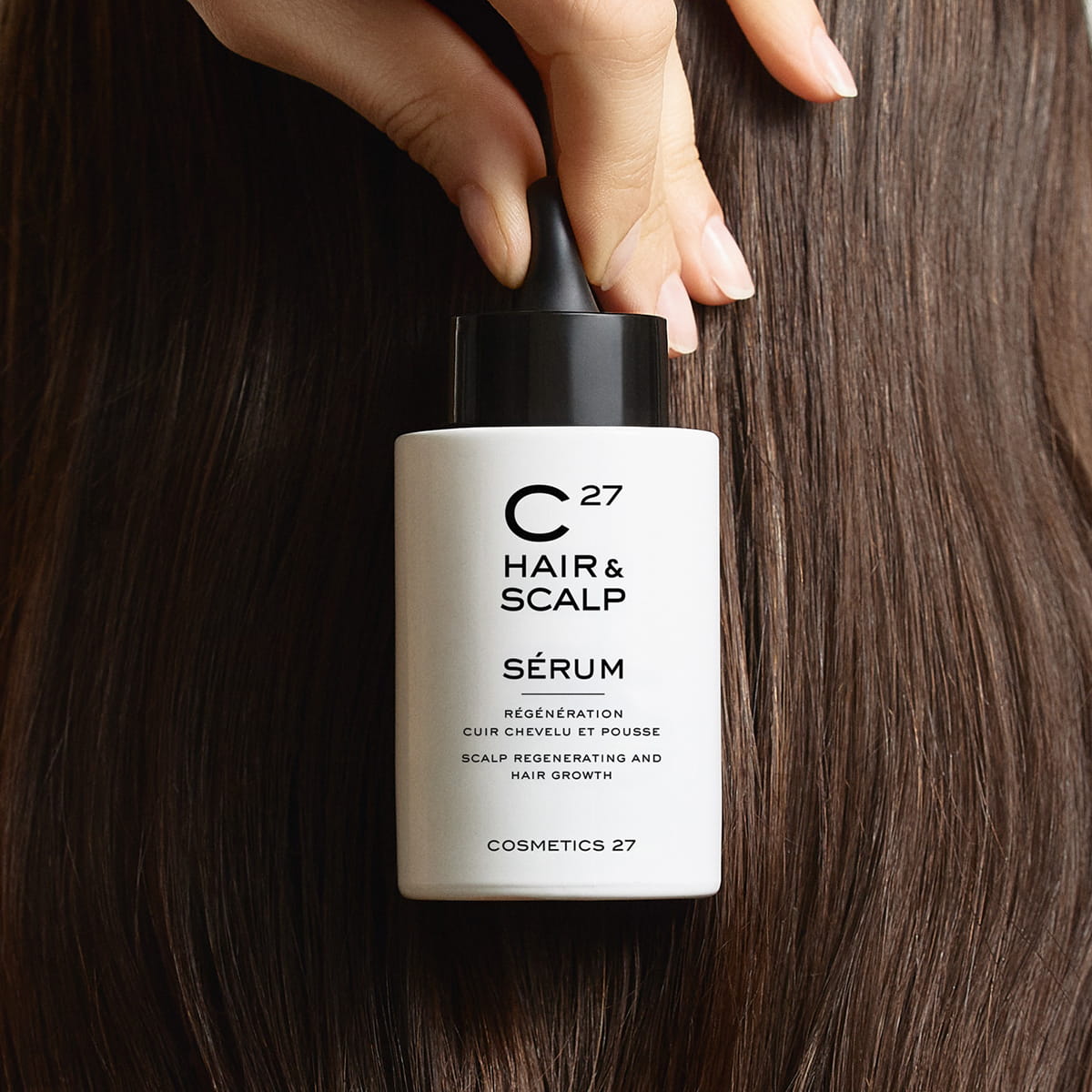 Cosmetics 27 Hair &amp; Scalp Serum (50 ml) - product shown being held next to hair. 