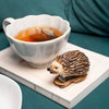 Nach Hedgehog Stapler (1 pc) - product shown on top of book and next to tea. 