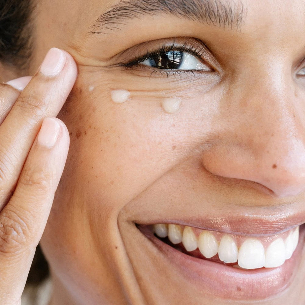 Ursa Major Sunny Start Eye Serum (0.5 oz) - product shown being applied onto skin.
