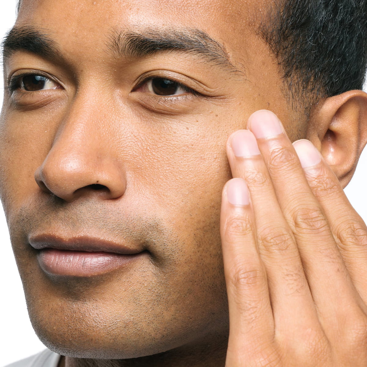 Ursa Major Sunny Start Eye Serum (0.5 oz) - model shown up close with hand on face. 