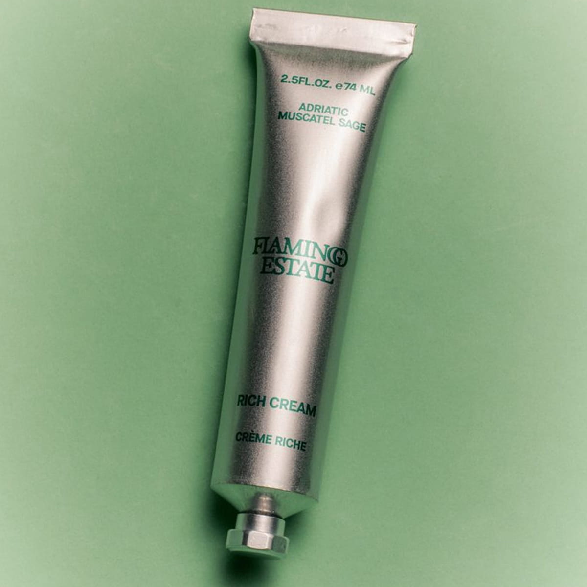 Flamingo Estate Adriatic Muscatel Sage Rich Cream (74 ml) - on green background. 
