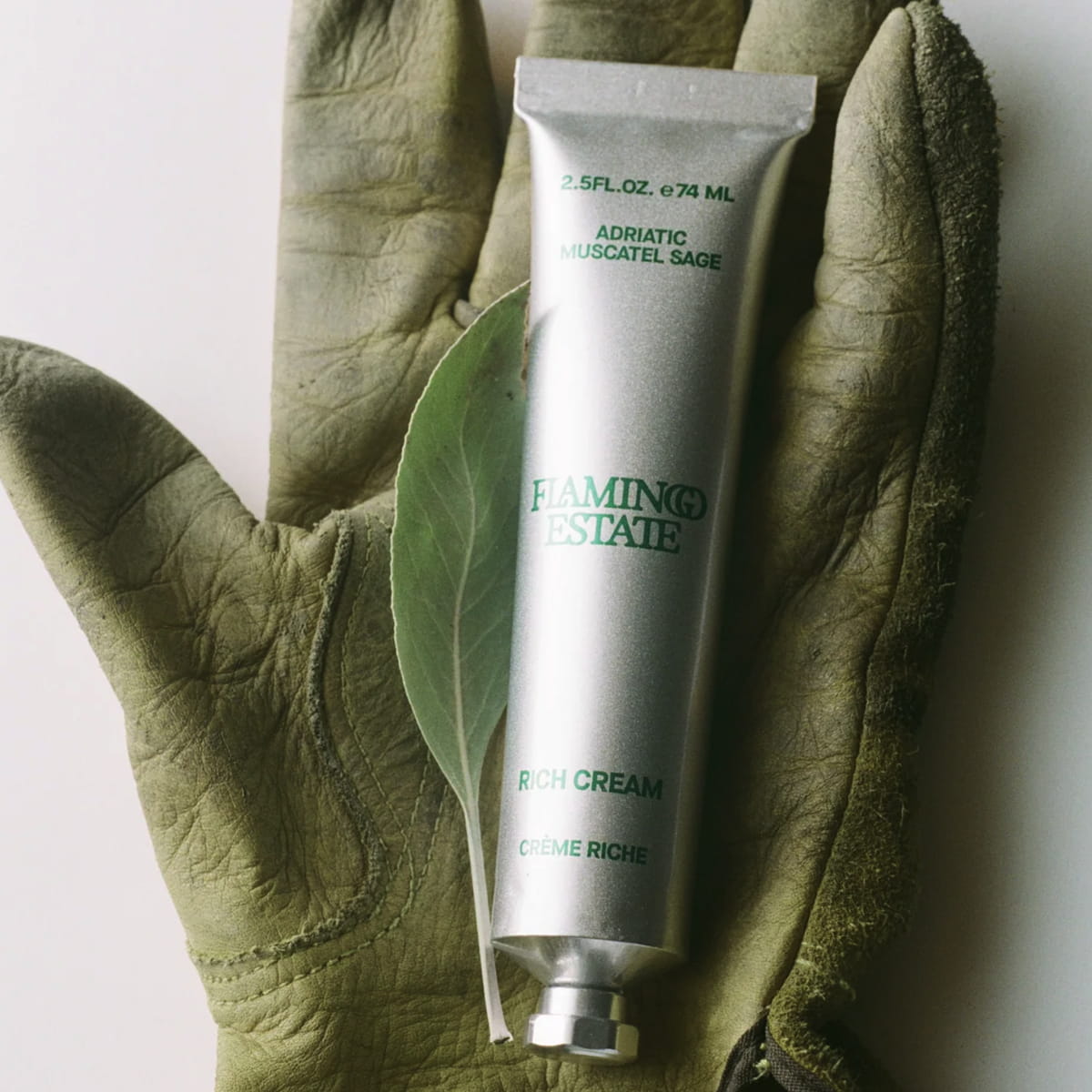 Flamingo Estate Adriatic Muscatel Sage Rich Cream (74 ml) - product shown inside a gardeners glove.
