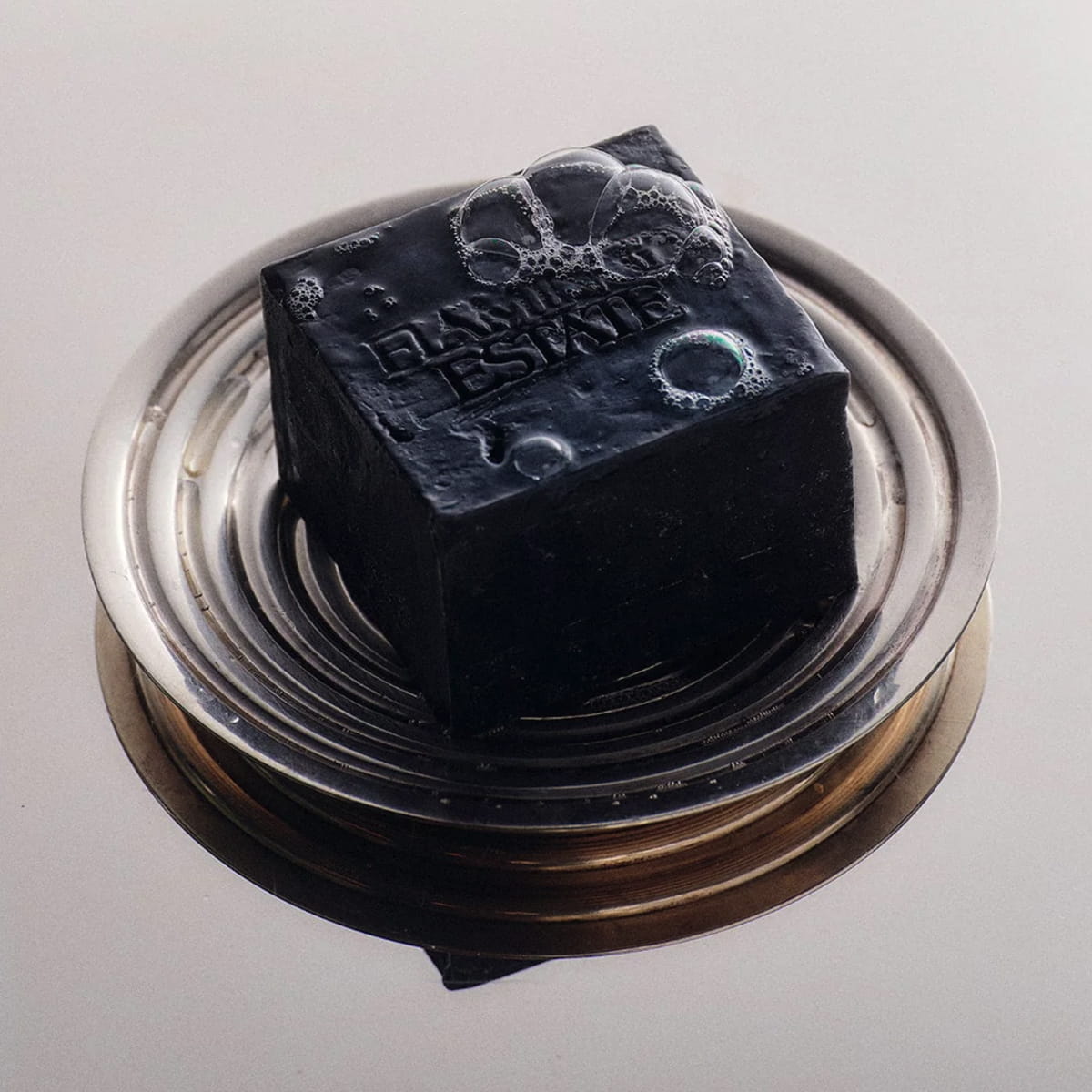 Flamingo Estate Lavender Activated Charcoal Soap Brick (340 g) - product shown on plate. 