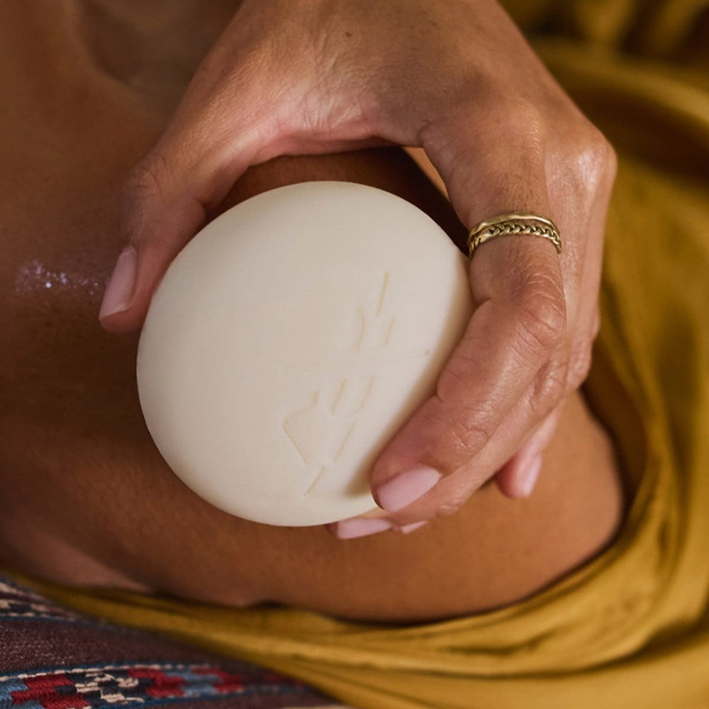 Kate McLeod The Bug Balm Lotion Bar (3.5 oz) - product shown being applied to shoulder.
