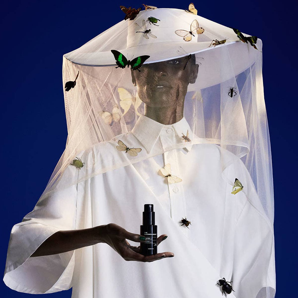 Heretic Parfum The Entomologist Insect Repellent Spray (50 ml) - product shown being held by model. 