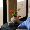 ROEN Candles Hakone Scented Candle (8 oz) - product shown on wooden table. 