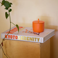ROEN Candles Fushimi Scented Candle (8 oz) - product shown on top of book. 