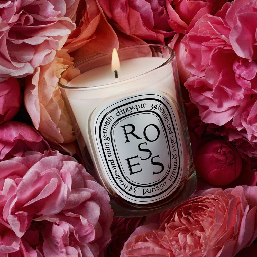 Diptyque Roses Classic Candle (190 g) - product shown in the middle of flowers. 