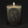 Diptyque Roses Classic Candle (190 g) - product shown lit on dark background. 