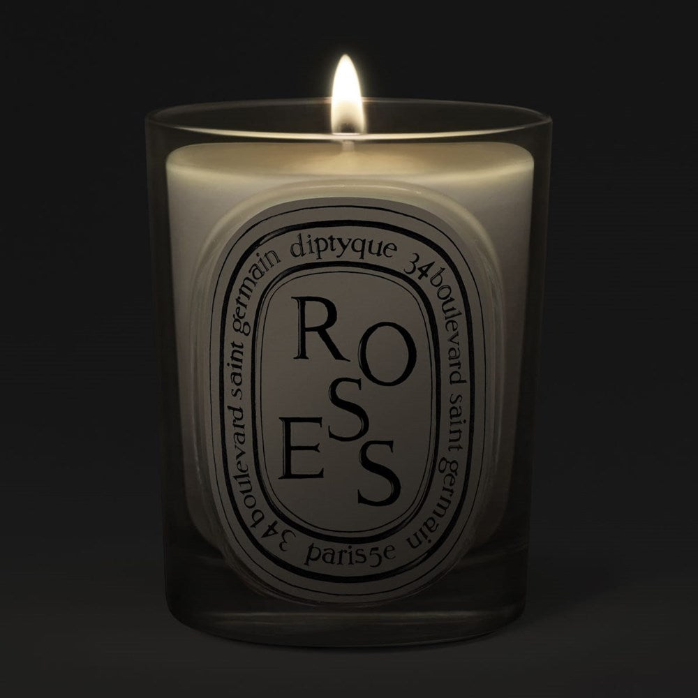 Diptyque Roses Classic Candle (190 g) - product shown lit on dark background. 