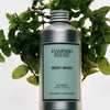 Flamingo Estate Peppermint Juniper Berry Body Wash (355 ml) with peppermint in the background