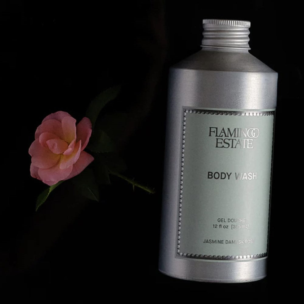 Flamingo Estate Jasmine Damask Rose Body Wash (355 ml) with a pink flower on a black background
