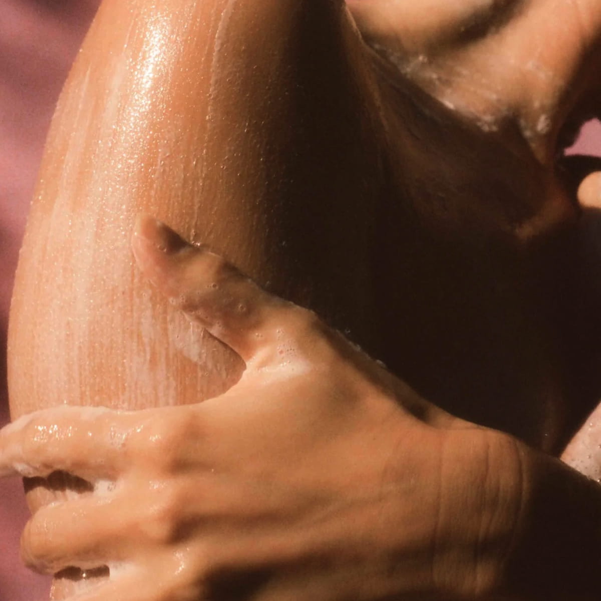 Close up of model using Flamingo Estate Jasmine Damask Rose Body Wash (355 ml)