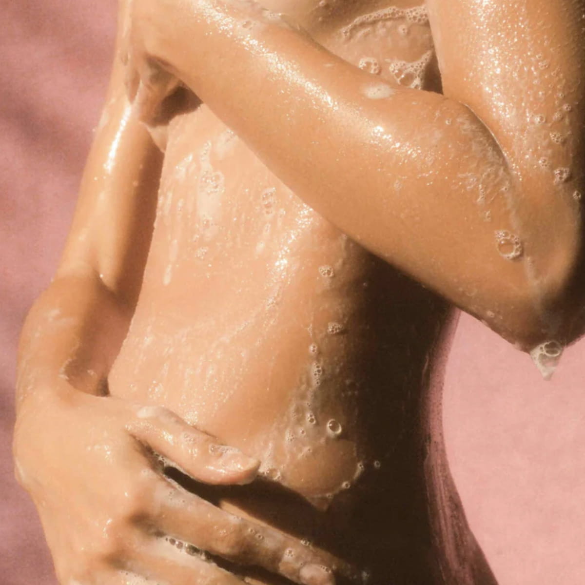 Close up of model using Flamingo Estate Jasmine Damask Rose Body Wash (355 ml)