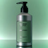 Lifestyle shot of Flamingo Estate Rosemary Clary Sage Conditioner (355 ml) against green background