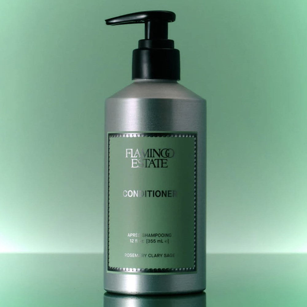 Lifestyle shot of Flamingo Estate Rosemary Clary Sage Conditioner (355 ml) against green background
