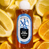Skin & Co Blue in Capri Body Wash (250 ml) with lemons and oranges in the background
