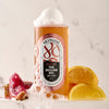 Lifestyle shot of Skin & Co The Sicilian Gel Body Wash (250 ml) with ingredients including lemons in the background