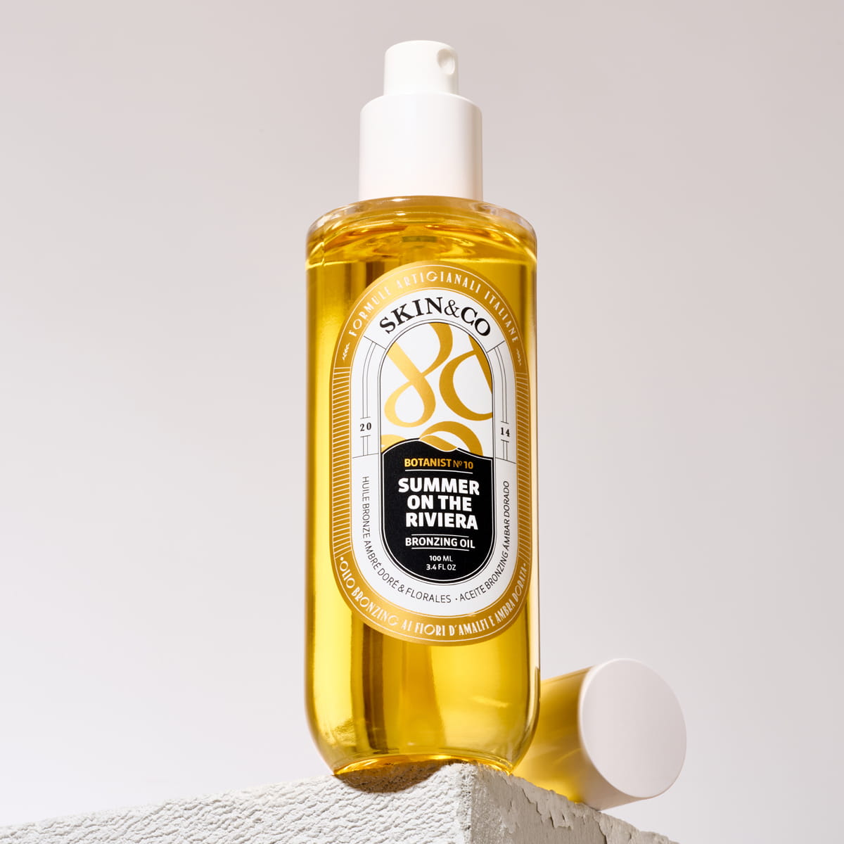 Lifestyle shot of Skin & Co Summer On the Riviera Bronzing Oil (100 ml) shown with cap off